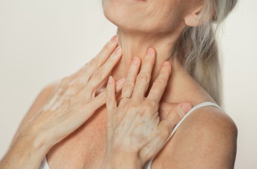 Anonymous Senior Woman Touching Her Neck, Chest, with Hands, Enjoying Soft Skin. Elderly Female Natural Beauty. Dignity and Grace in Old Age. Isolated Background for Skin care, Healthy Living Concept